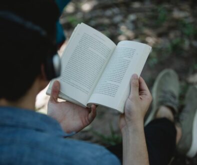 crop man in headphones reading book